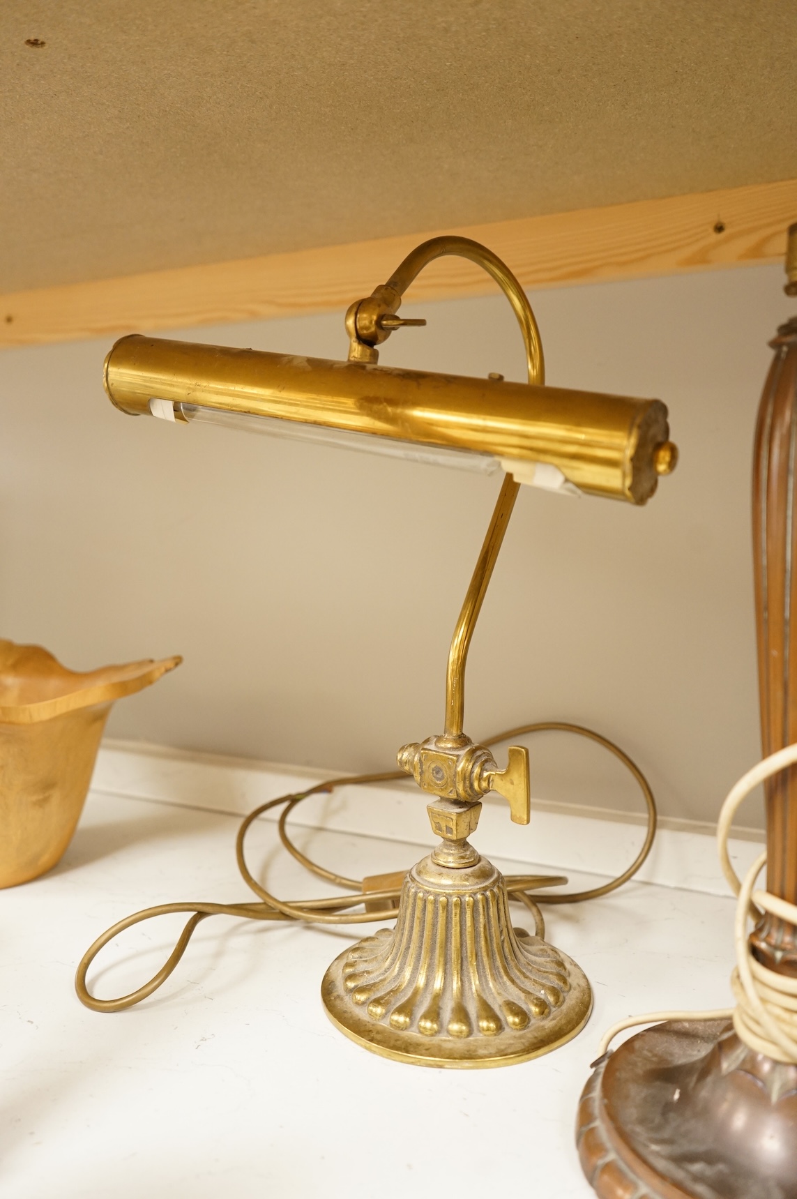 A copper table lamp and a brass students lamp
